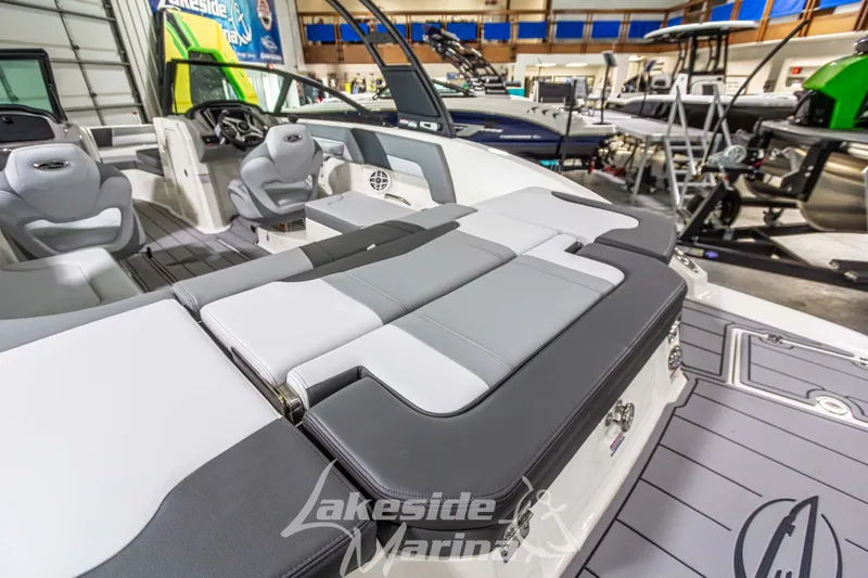 Slide: The Image of 2026 Chaparral 23 SSi boat interior with sleek seating and modern design in showroom. - 2