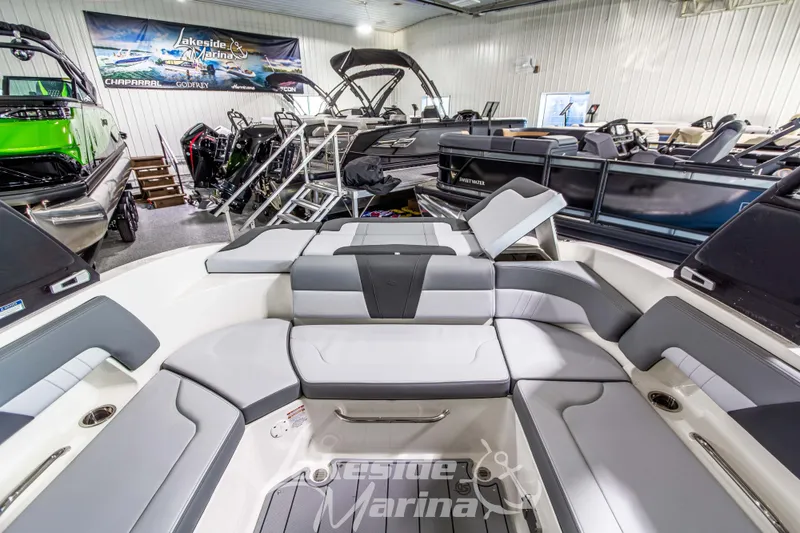 Slide: The Image of 2026 Chaparral 23 SSi boat interior at Lakeside Marina showroom, featuring sleek seating design. - 7