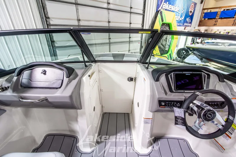 Slide: The Image of 2026 Chaparral 23 SSi boat interior with modern dashboard and steering wheel. - 16