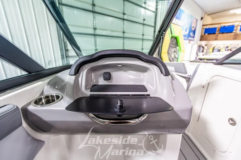 Slide: The Image of 2026 Chaparral 23 SSi boat interior with dashboard and cup holder at Lakeside Marina. - 15