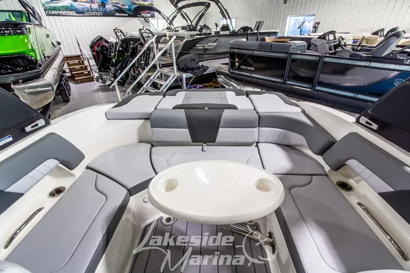 Slide: The Image of 2026 Chaparral 23 SSi boat interior with plush seating and table at Lakeside Marina. - 11