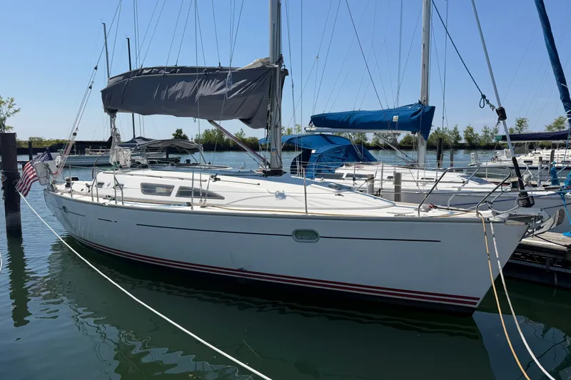 Slide: The Image of 2003 Jeanneau Sun Fast 37 sailboat docked in a marina under clear skies. - 3