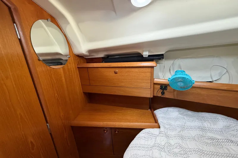 Slide: The Image of Cozy cabin interior of 2003 Jeanneau Sun Fast 37 sailboat with wooden cabinetry and bedding. - 30