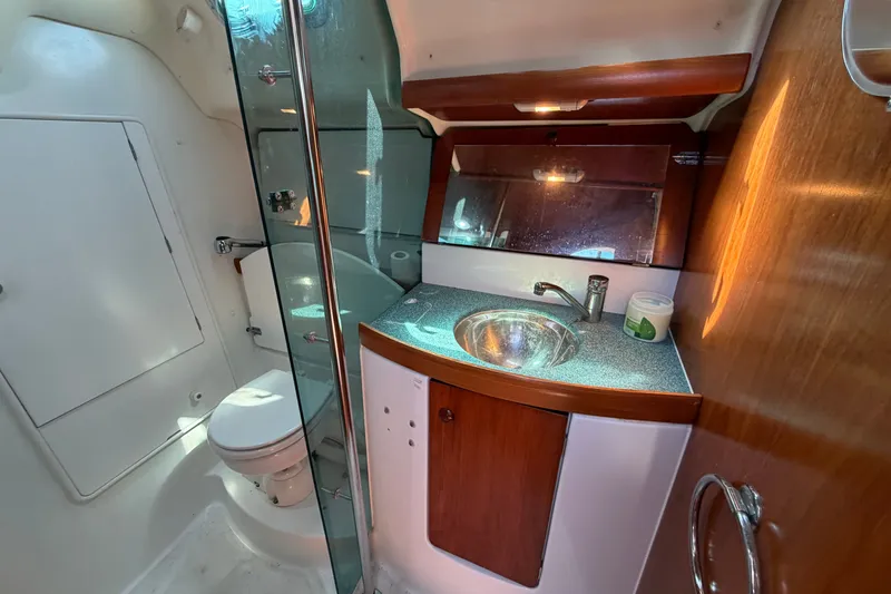 Slide: The Image of 2003 Jeanneau Sun Fast 37 yacht bathroom with modern fixtures and wooden cabinetry. - 33