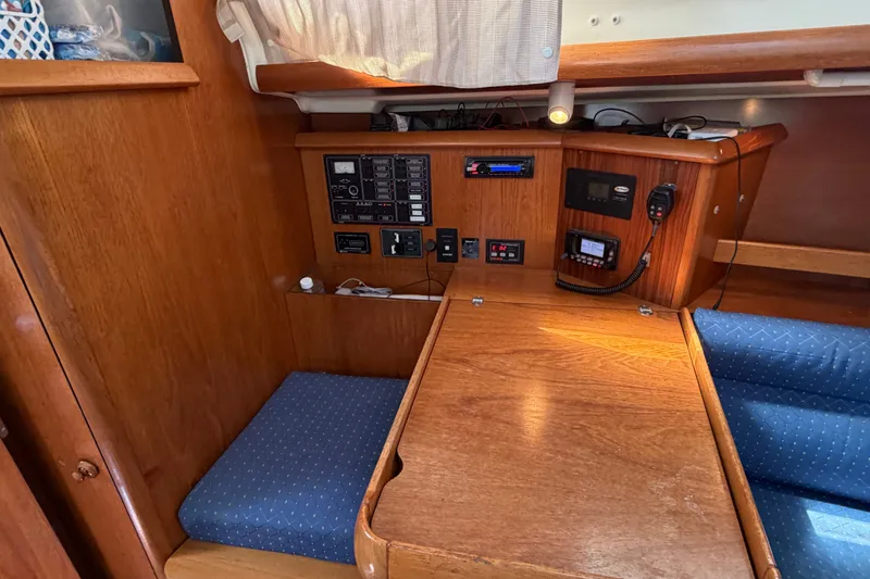 Slide: The Image of Interior of 2003 Jeanneau Sun Fast 37 sailboat with navigation station and wooden cabinetry. - 16