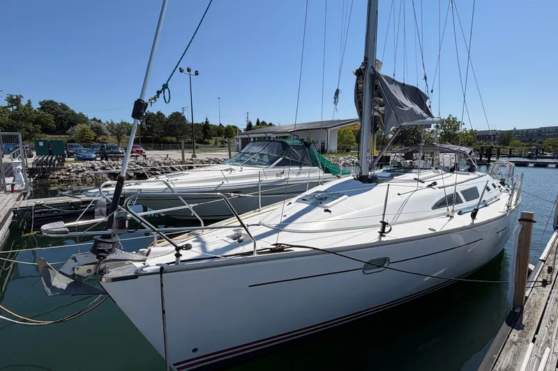 The Image of 2003 Jeanneau Sun Fast 37 sailboat docked at a marina under clear blue skies. - 0