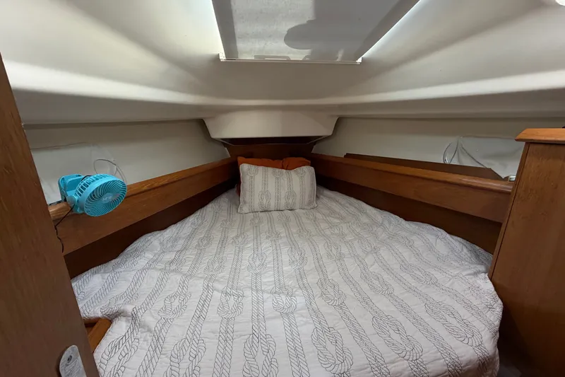 Slide: The Image of Cozy cabin interior of 2003 Jeanneau Sun Fast 37 sailboat with bed and fan. - 28