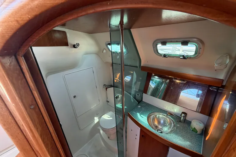 Slide: The Image of Interior of 2003 Jeanneau Sun Fast 37 yacht bathroom with sink, toilet, and window. - 31