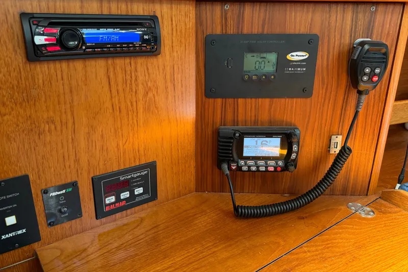 Slide: The Image of Control panel of a 2003 Jeanneau Sun Fast 37 yacht with radio and navigation equipment. - 18