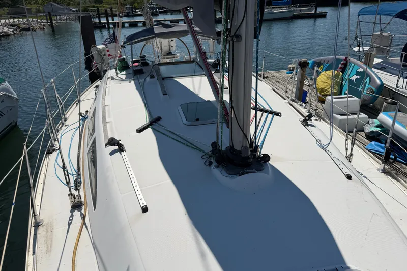 Slide: The Image of 2003 Jeanneau Sun Fast 37 sailboat docked at marina, showcasing deck and rigging. - 6