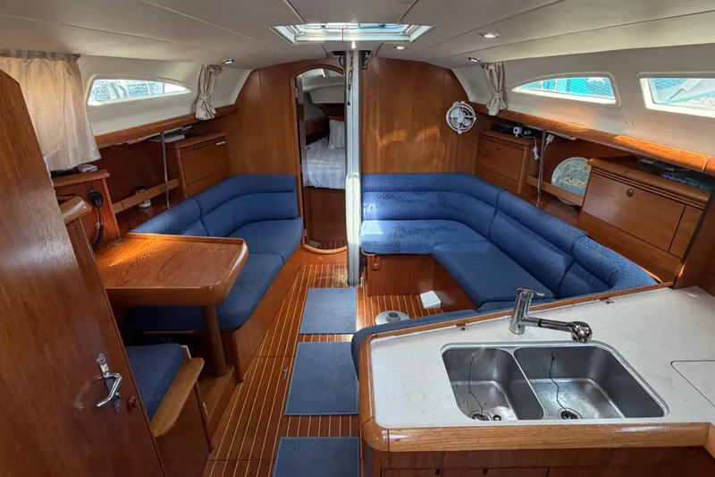 Slide: The Image of Interior of 2003 Jeanneau Sun Fast 37 yacht with blue seating and wooden finishes. - 15