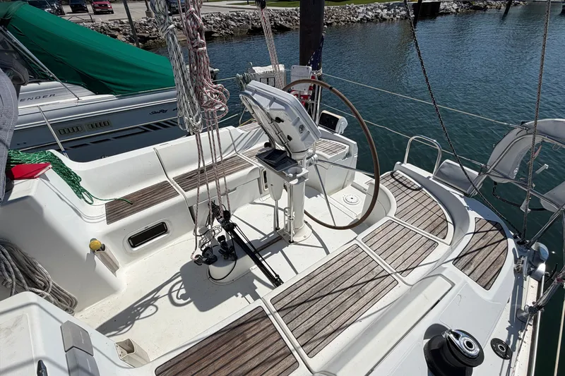 Slide: The Image of Cockpit of 2003 Jeanneau Sun Fast 37 sailboat with wooden deck and steering wheel. - 10