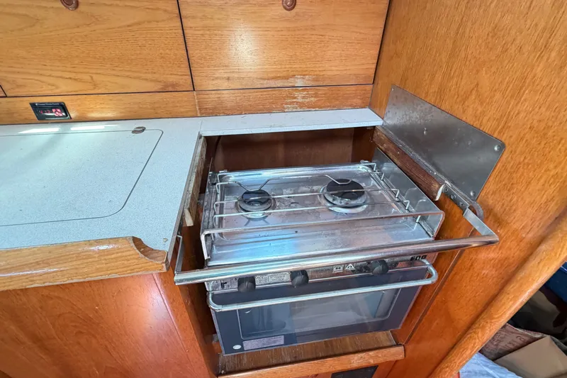 Slide: The Image of Compact kitchen stove in 2003 Jeanneau Sun Fast 37 sailboat galley. - 26