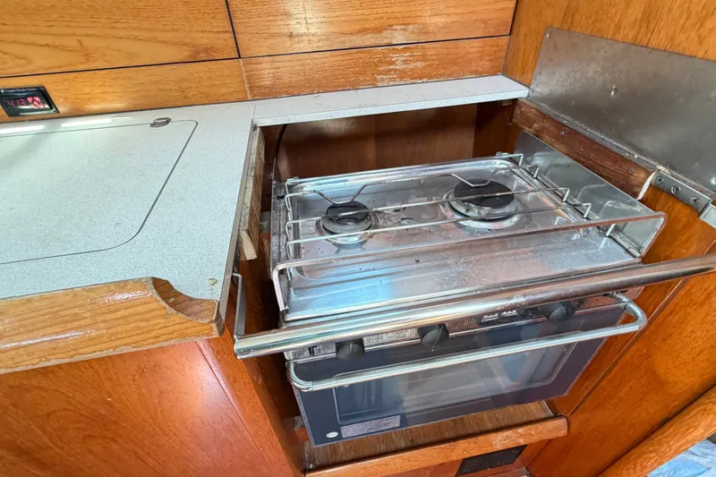 Slide: The Image of Jeanneau Sun Fast 37 yacht kitchen with stove, 2003 model, wooden cabinetry. - 27