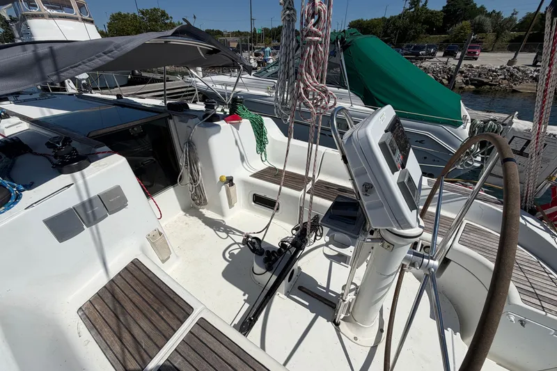 Slide: The Image of 2003 Jeanneau Sun Fast 37 sailboat cockpit with steering wheel and navigation equipment. - 13