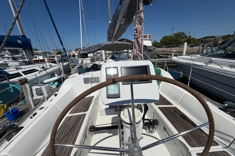 Slide: The Image of 2003 Jeanneau Sun Fast 37 sailboat cockpit with steering wheel and navigation instruments. - 12