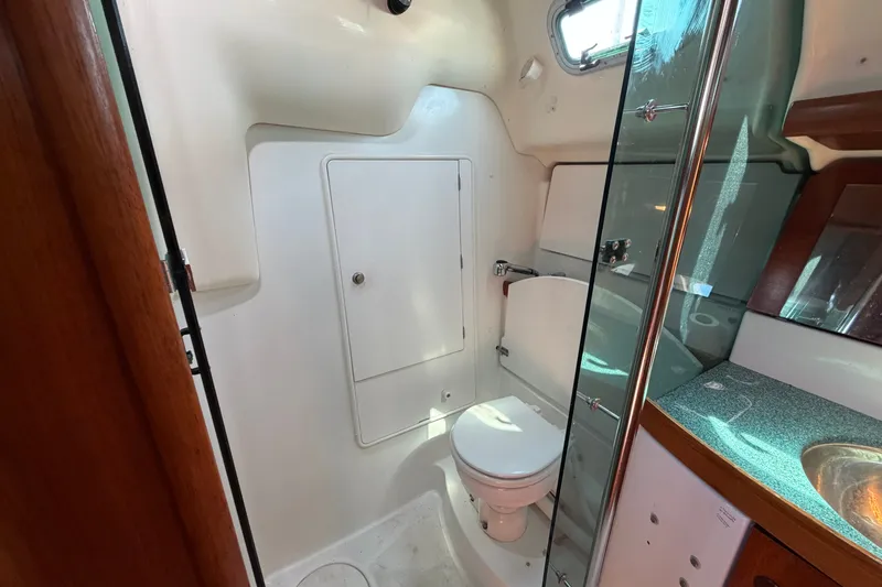 Slide: The Image of Bathroom interior of 2003 Jeanneau Sun Fast 37 yacht, featuring toilet and sink. - 32