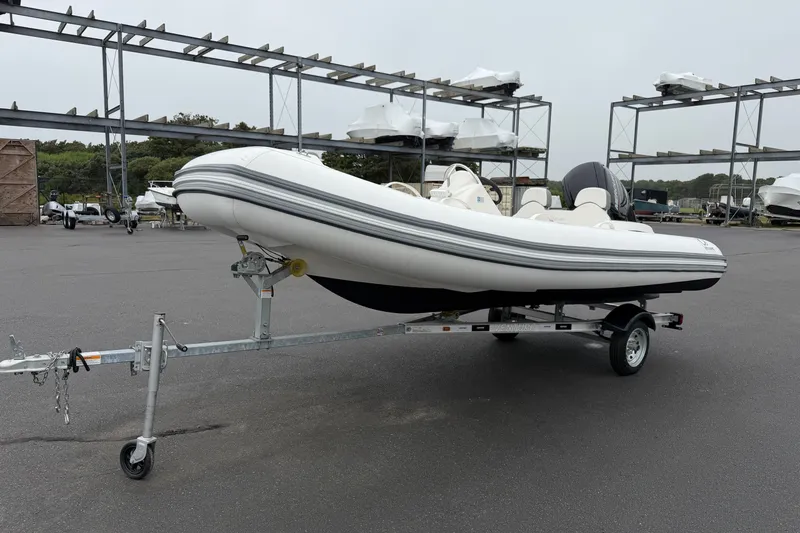 The Image of 2024 Zodiac Yachtline 490 inflatable boat on trailer in a marina setting. - 1