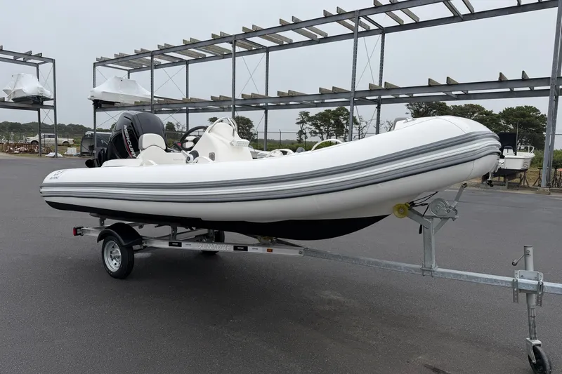 Slide: The Image of 2024 Zodiac Yachtline 490 inflatable boat on trailer, parked outdoors. - 3