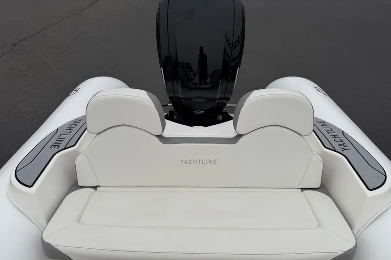 Slide: The Image of 2024 Zodiac Yachtline 490 boat interior with sleek white seating and modern design. - 8
