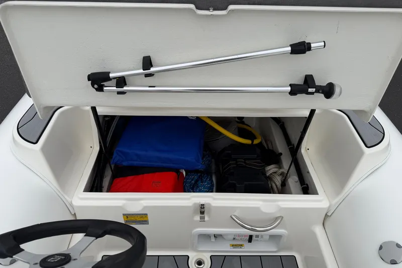 Slide: The Image of Open storage compartment on 2024 Zodiac Yachtline 490, showing boating equipment and accessories. - 9