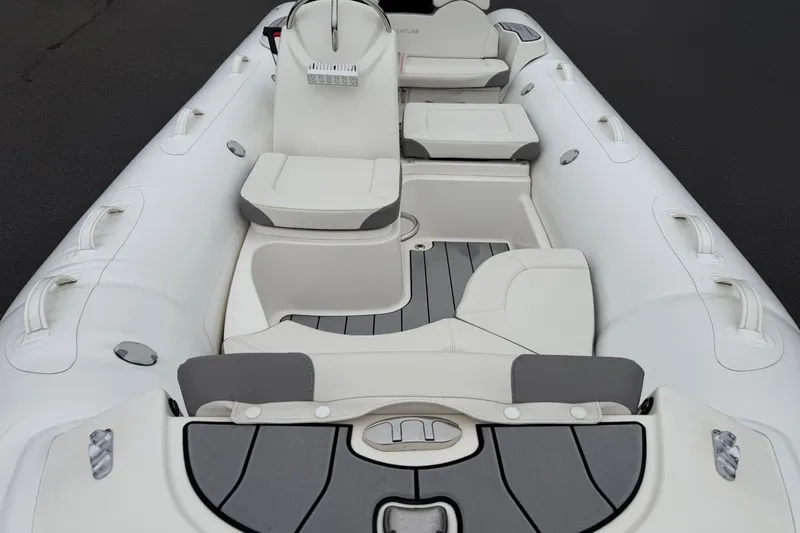 Slide: The Image of 2024 Zodiac Yachtline 490 inflatable boat interior with white seating and gray accents. - 5