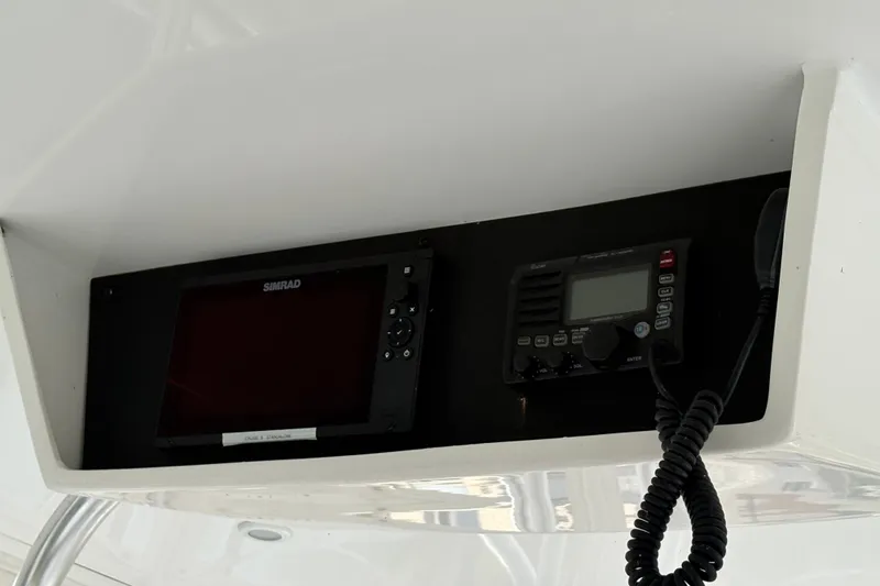 Slide: The Image of Simrad marine electronics on 2001 Blackfin 33 Flybridge boat dashboard. - 11