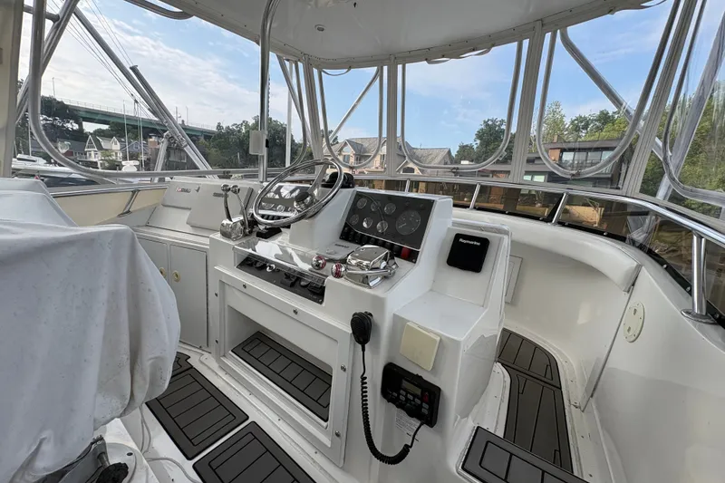 Slide: The Image of Flybridge of 2001 Blackfin 33, featuring steering wheel, controls, and navigation equipment. - 7