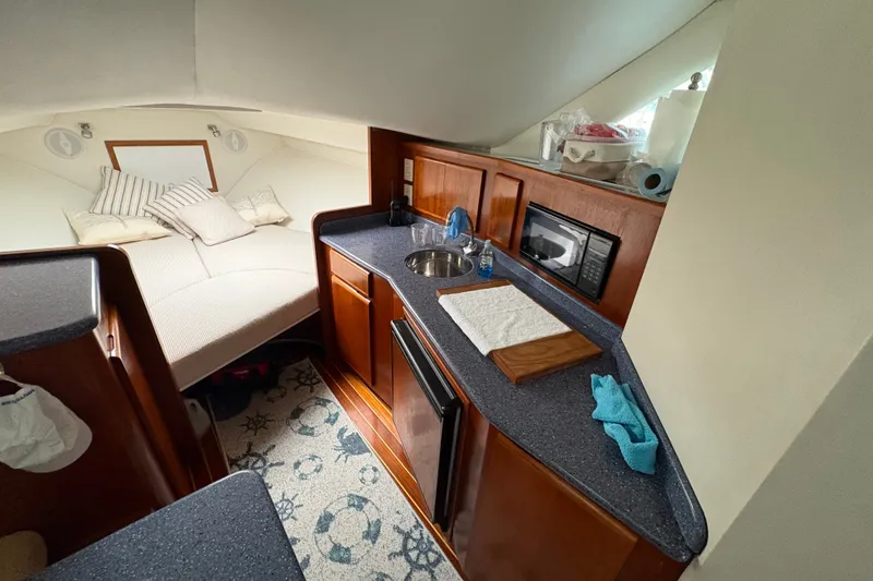 Slide: The Image of Interior of 2001 Blackfin 33 Flybridge with kitchenette and cozy sleeping area. - 14