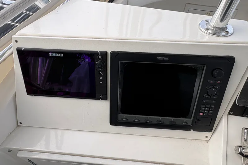 Slide: The Image of Simrad navigation displays on 2001 Blackfin 33 Flybridge boat dashboard. - 9