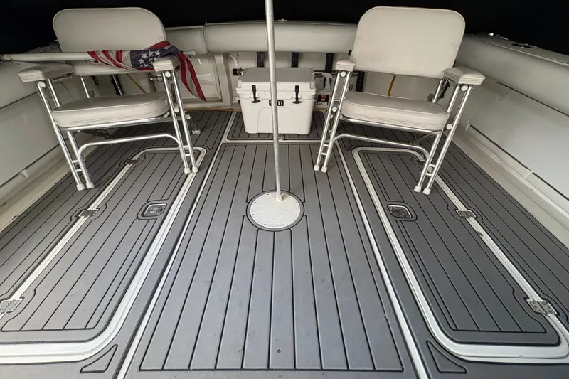 Slide: The Image of Interior of 2001 Blackfin 33 Flybridge with chairs and cooler on deck. - 12