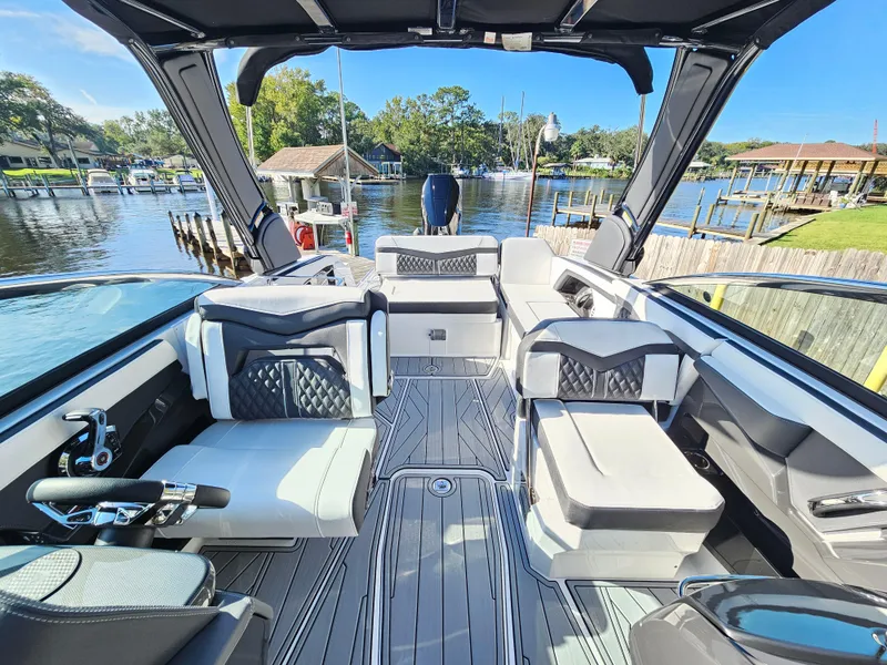 Slide: The Image of 2025 Monterey 255SS boat interior with luxurious seating and modern design on a sunny day. - 28