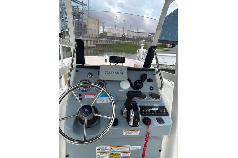 Slide: The Image of 2024 Trophy CC22 boat dashboard with Garmin navigation system and steering wheel. - 4