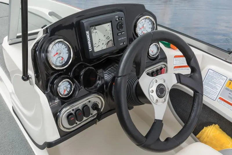 Slide: The Image of The image shows the dashboard of a Nitro Z-7 Sport boat with a steering wheel and multiple gauges. - 13