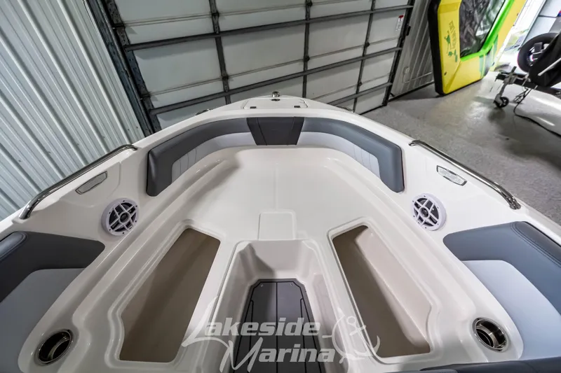 Slide: The Image of 2026 Chaparral 21 SSi boat interior with gray seating and storage compartments. - 23