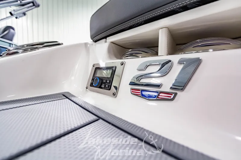 Slide: The Image of 2026 Chaparral 21 SSi boat interior with control panel and logo detail. - 2