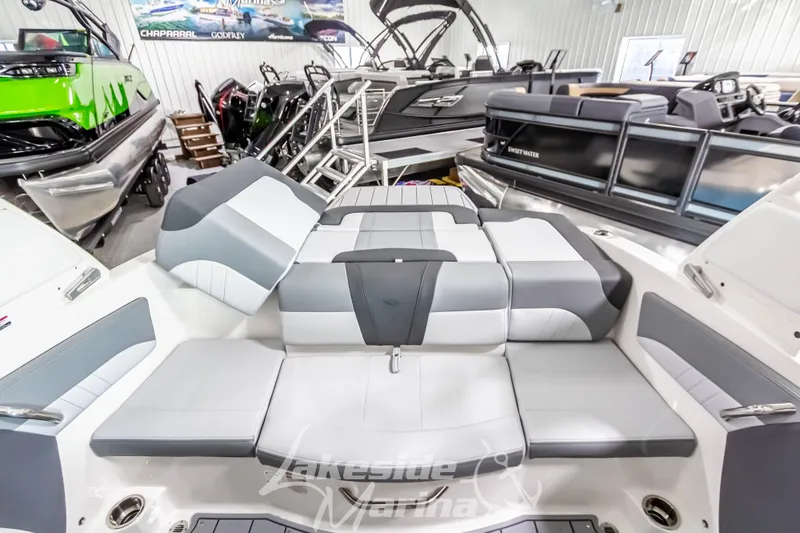 Slide: The Image of 2026 Chaparral 21 SSi boat interior with gray and white seating at Lakeside Marina. - 11