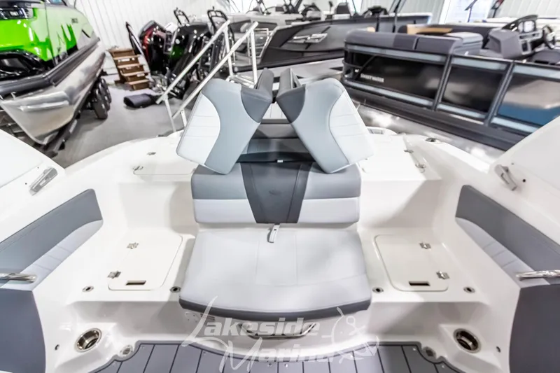 Slide: The Image of 2026 Chaparral 21 SSi boat interior with gray and white seating in showroom. - 7