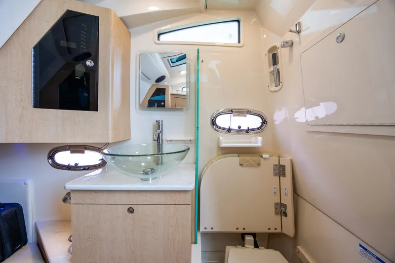 Slide: The Image of Luxurious bathroom interior of 2017 Boston Whaler 370 Outrage with glass sink and modern fixtures. - 45