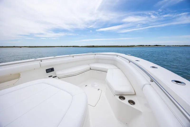 Slide: The Image of 2017 Boston Whaler 370 Outrage boat interior with white seating and ocean view. - 38