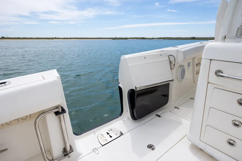 Slide: The Image of 2017 Boston Whaler 370 Outrage boat interior with open side door, ocean view. - 20