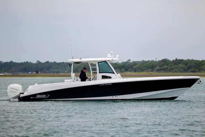 Slide: The Image of 2017 Boston Whaler 370 Outrage boat cruising on calm waters. - 7
