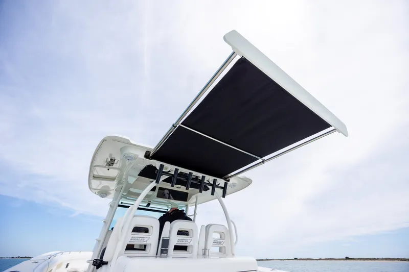 Slide: The Image of 2017 Boston Whaler 370 Outrage boat with extended sunshade on open water. - 27