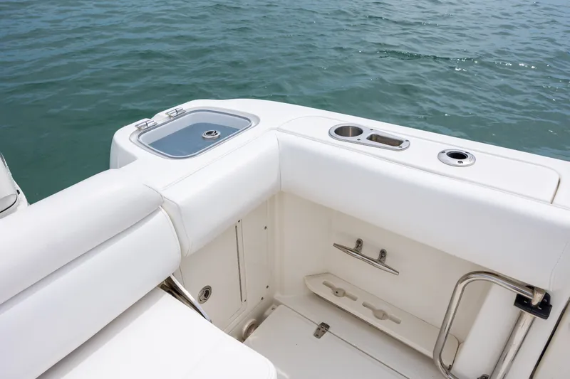 Slide: The Image of 2017 Boston Whaler 370 Outrage boat interior with white seating and ocean view. - 18