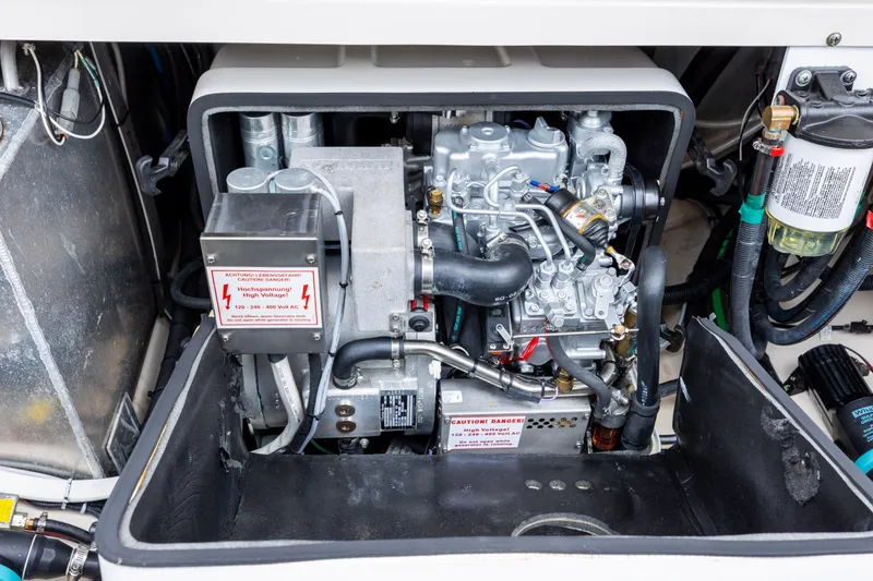 Slide: The Image of Engine compartment of a 2017 Boston Whaler 370 Outrage, showcasing high voltage components. - 49