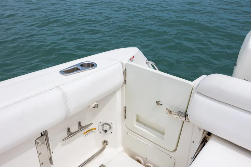 Slide: The Image of 2017 Boston Whaler 370 Outrage boat interior with open door and cup holder. - 19