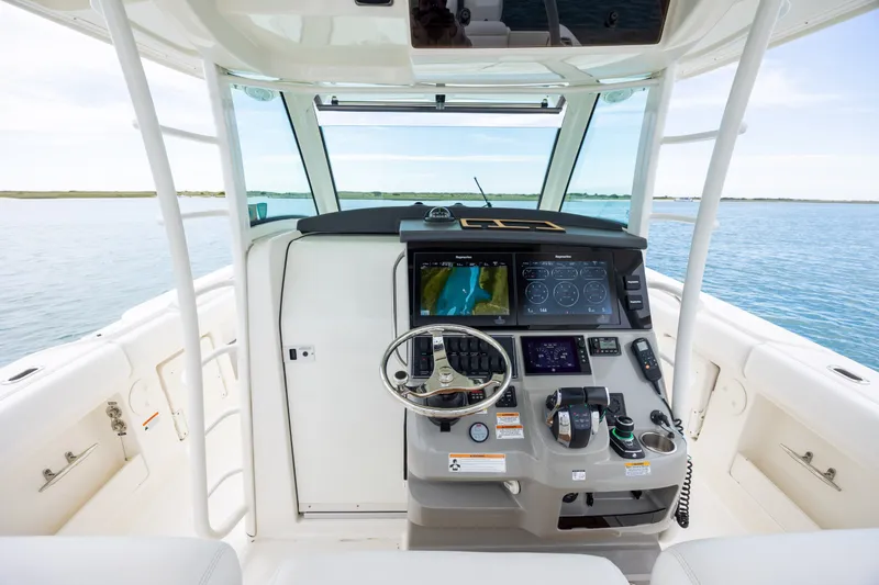 Slide: The Image of 2017 Boston Whaler 370 Outrage helm with advanced navigation system on calm waters. - 29