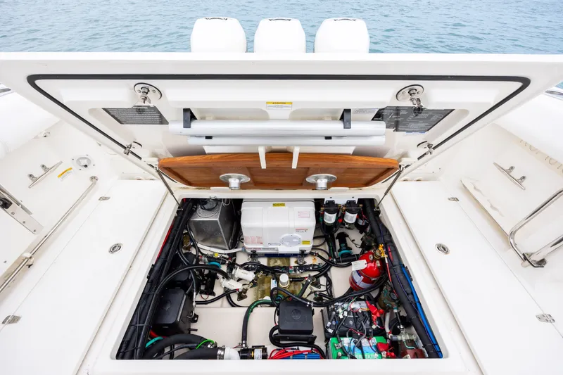 Slide: The Image of Engine compartment of a 2017 Boston Whaler 370 Outrage boat, showcasing detailed components. - 43
