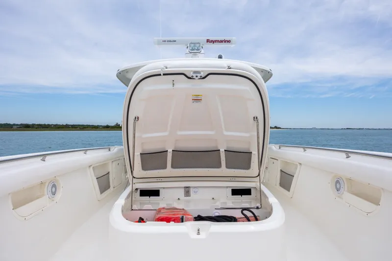 Slide: The Image of 2017 Boston Whaler 370 Outrage boat storage compartment open on calm water. - 41