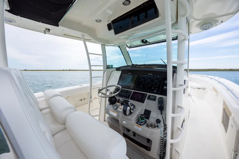 Slide: The Image of 2017 Boston Whaler 370 Outrage helm with advanced navigation system on calm waters. - 28